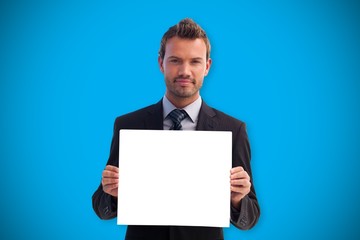 Composite image of businessman showing card