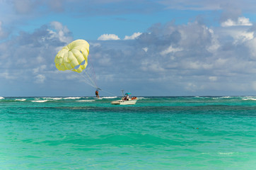 A parachute being towed at sea with a clear blue sky