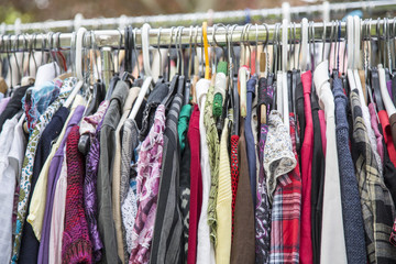 clothes on a rack in a flea market