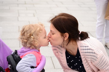 Mom and daughter kissing