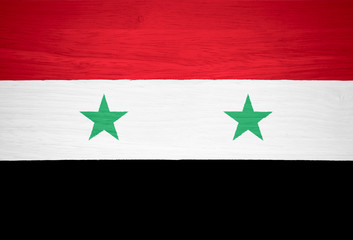 Syria flag on wood texture