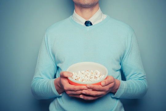 Man with bowl of popcorn