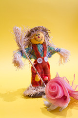 A funny colorful scarecrow with the flower