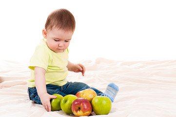 Fototapeta premium little baby playing with apples