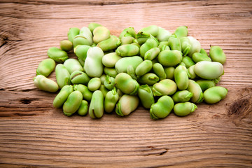Fresh broad bean on old wooden background