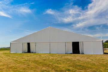 Large white party tent if a field