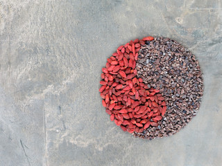 Goji berries and cacao nibs shaped in Yin Yang symbol