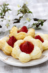 Puff pastry cookies in flower shape filled with strawberries