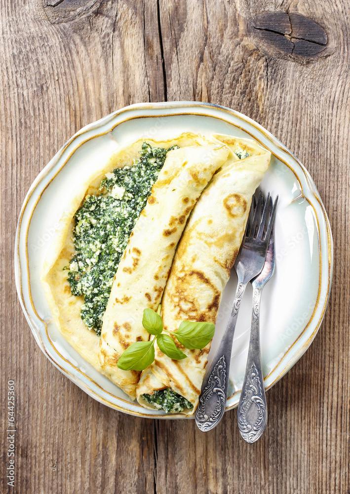 Poster mediterranean cuisine: crepes stuffed with cheese and spinach