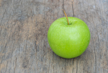 Green Apple on wood background