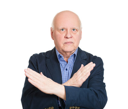 Senior man giving do not enter hand gesture, white background 