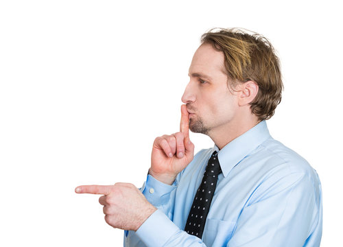Side view profile man pointing finger asking to be quiet
