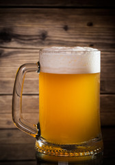 glass beer on wood background
