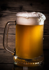 glass beer on wood background