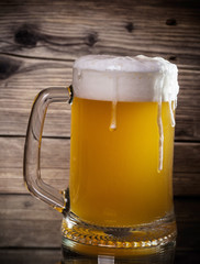 glass beer on wood background