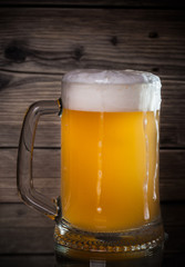 glass beer on wood background