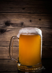 glass beer on wood background