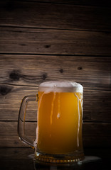 glass beer on wood background