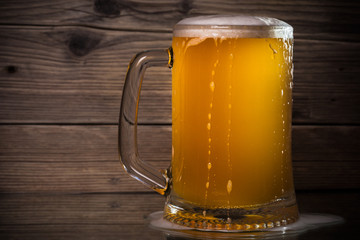 glass beer on wood background