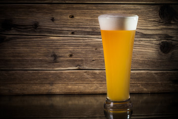 glass beer on wood background
