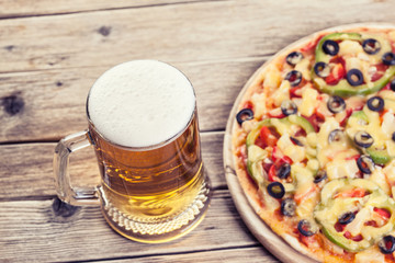 pizza on the table with a glass of beer