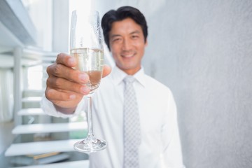 Happy man holding flute of champagne