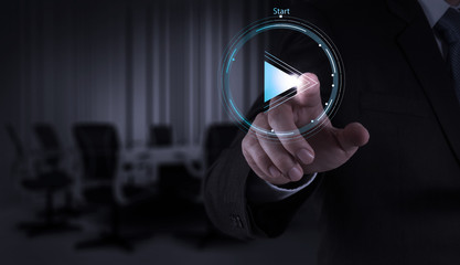 Businessman hand press play button sign to start or initiate pro