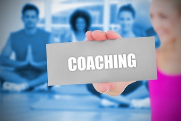 Fit blonde holding card saying coaching