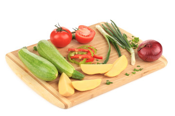 Composition of vegetables on wooden platter.
