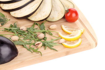 Close up of eggplant on wooden platter.