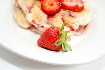 Close-Up of a Whole Strawberry in Front of Hotcakes
