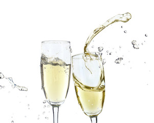 Glasses of champagne with splash, isolated on white