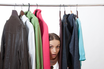 Young woman near rack with hangers