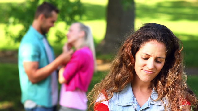 Upset girl watching her crush flirt with another girl
