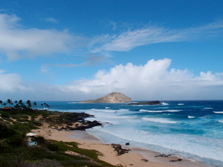 Empty beach due to large wave and view of islands on a cloud fil