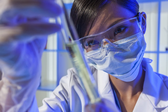 Chinese Woman Scientist With Test Tube In Laboratory