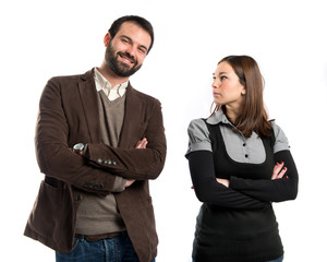 Couple with their arms crossed over isolated background