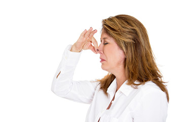 Something stinks. Woman pinches her nose doesn't like smell