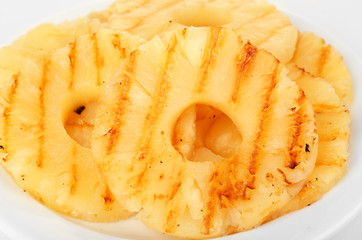 Juicy grilled pineapple on plate close-up