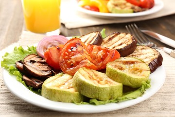 Delicious grilled vegetables on plate on table close-up