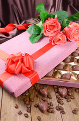 Delicious chocolates in box with flowers