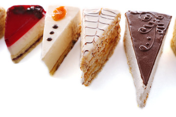 Assortment of pieces of cake, isolated on white © Africa Studio