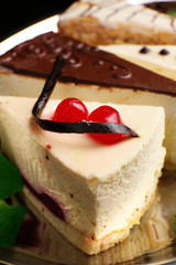 Assortment of pieces of cake, on dark background © Africa Studio