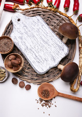 Different spices with blank cutting board, isolated on white