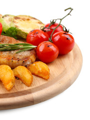 Grilled steak with fried potato pieces and grilled vegetables
