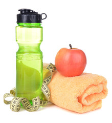 Sports bottle, apple,towel and measuring tape isolated on white