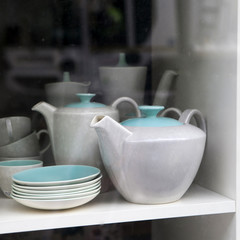 green and white caps and tea pot on  flea market
