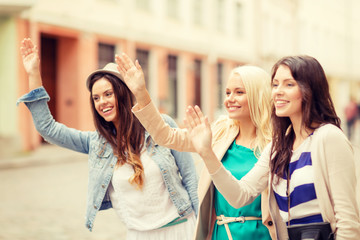 three beautiful girls waving hands