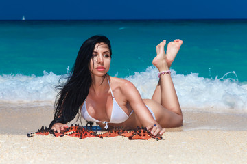 beautiful young brunette enjoying the sun on the tropical coast