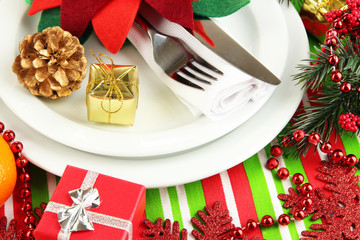 Christmas table setting with festive decorations close up